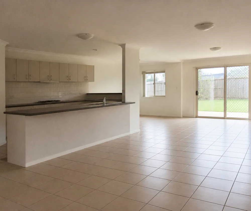 Bond cleaning in Clarkson, empty open-plan kitchen and living area with a wiped breakfast bar