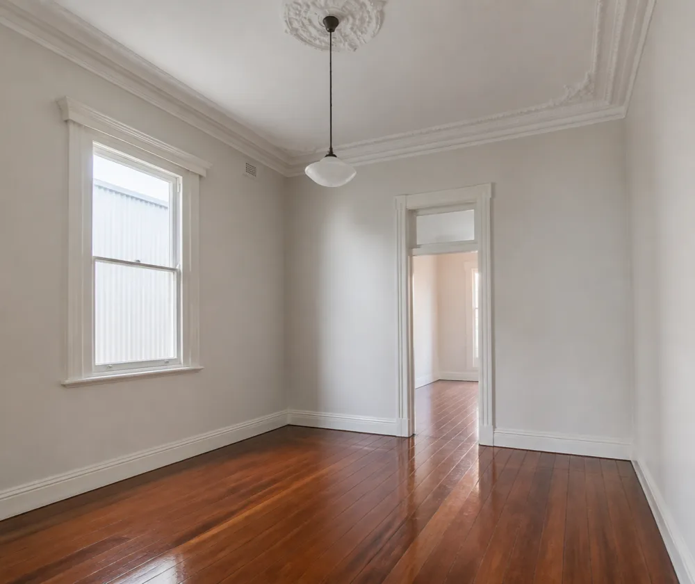 Bond cleaning in Subiaco, empty heritage room with polished timber floorboards and an ornate ceiling rose