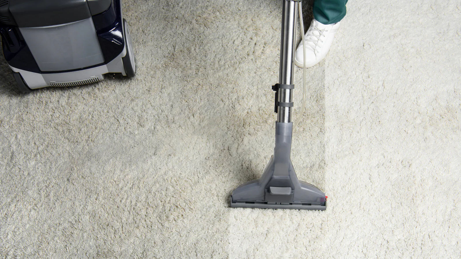 Carpet cleaning in progress on a pale carpet in a residential room