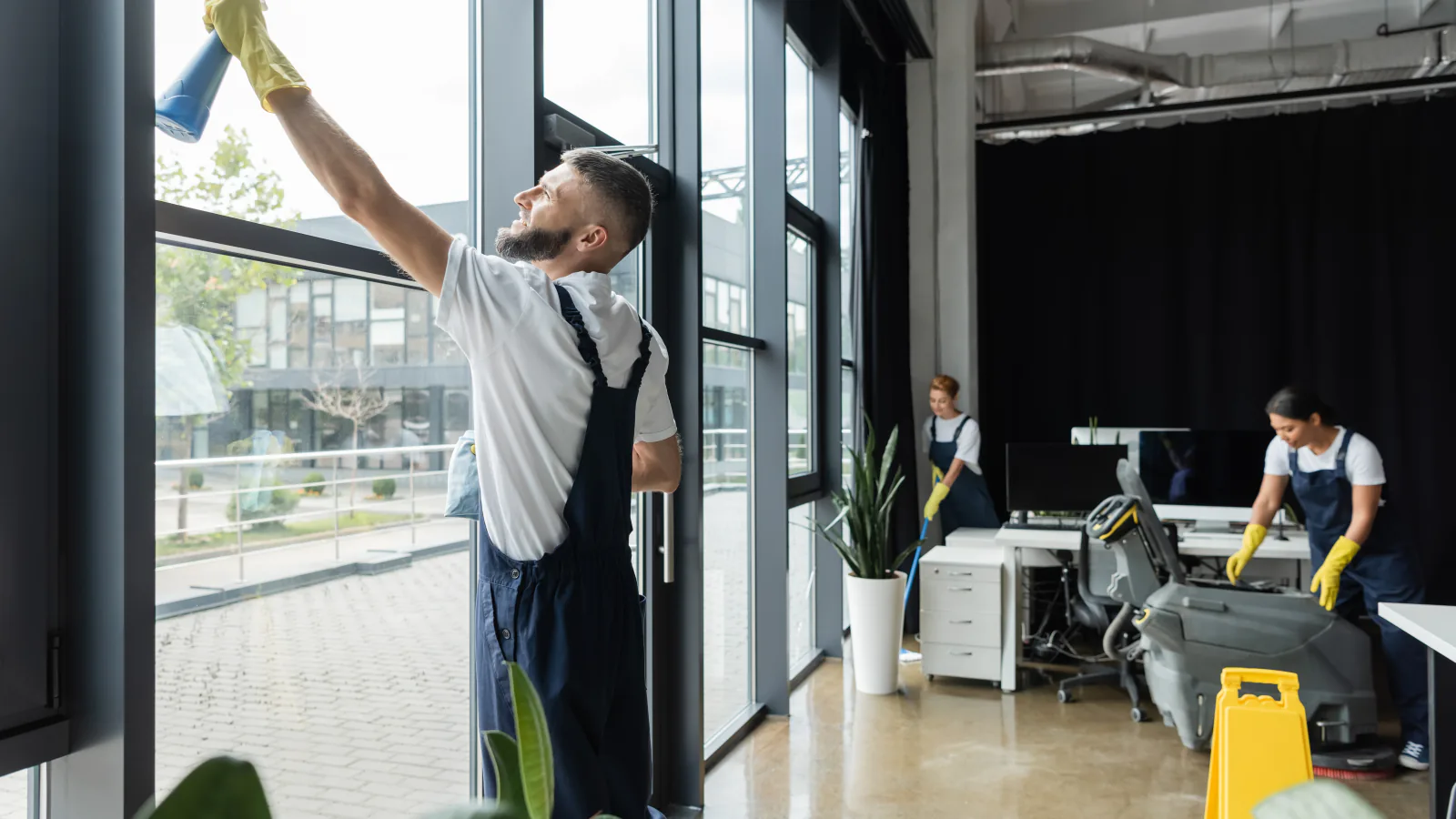 A large window being washed from the inside with a squeegee